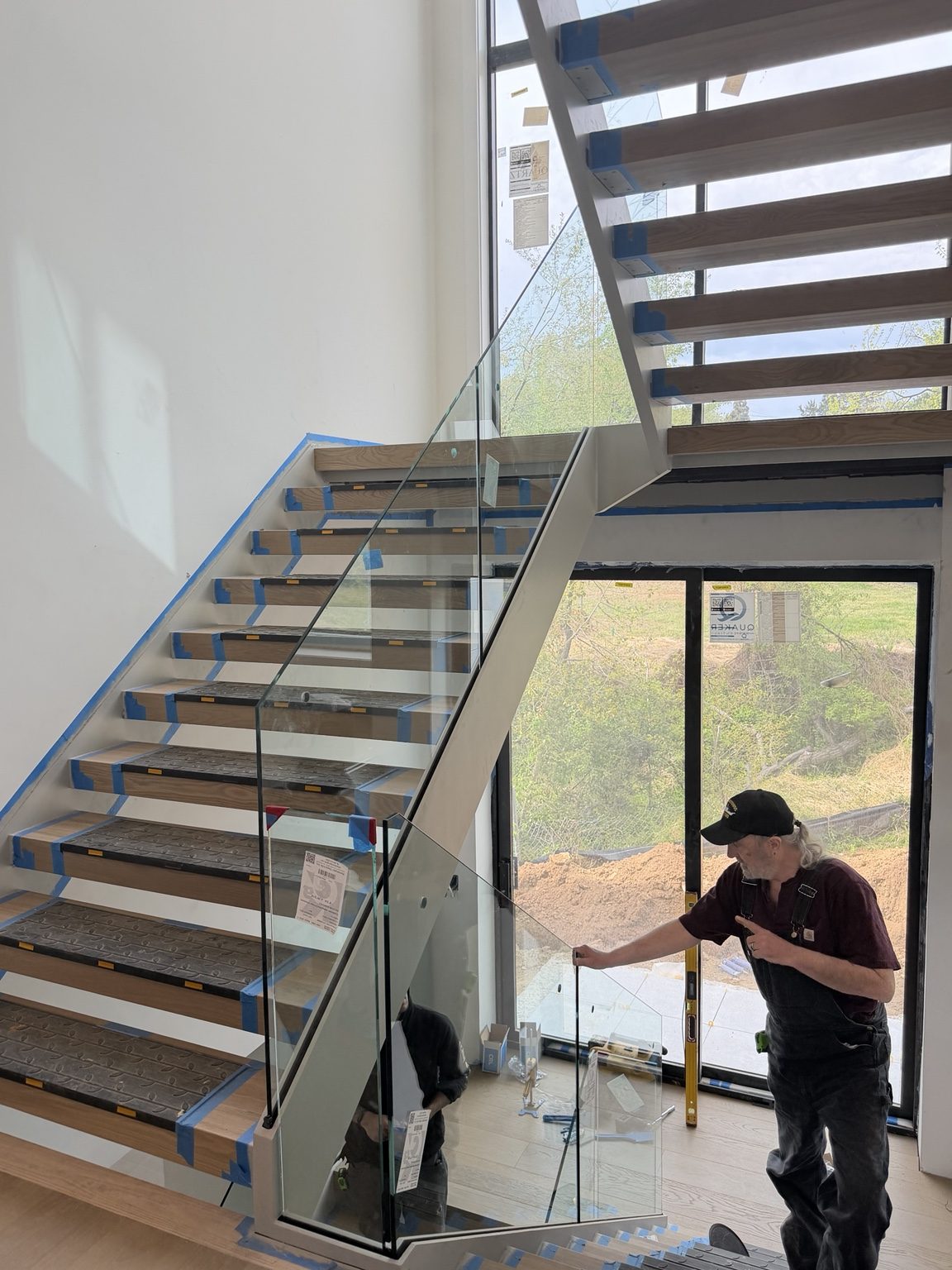 Finished open-riser stair with glass railing