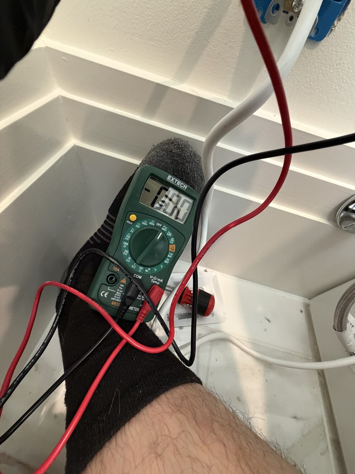 Checking voltage with a multimeter at an outlet