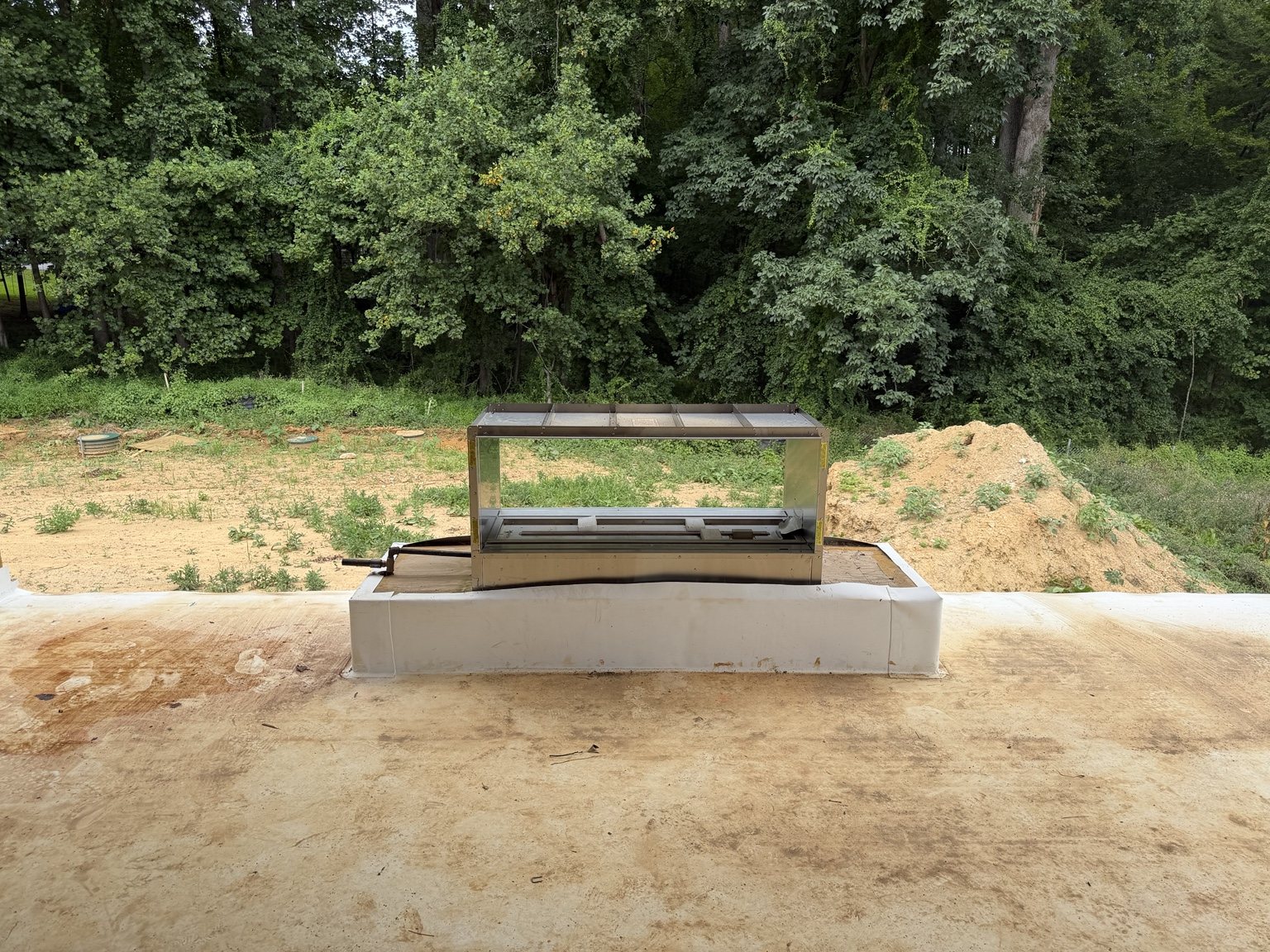 Exterior fireplace installation on a deck or terrace during construction